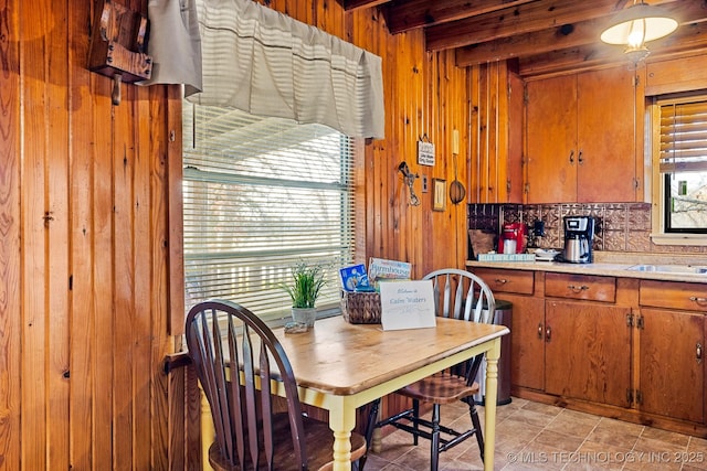 dining room with wood walls