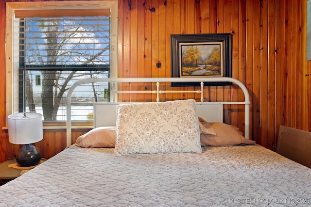 bedroom with wooden walls