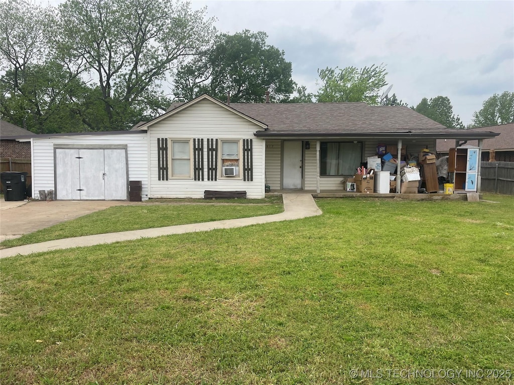ranch-style house featuring driveway, a front lawn, fence, and roof with shingles