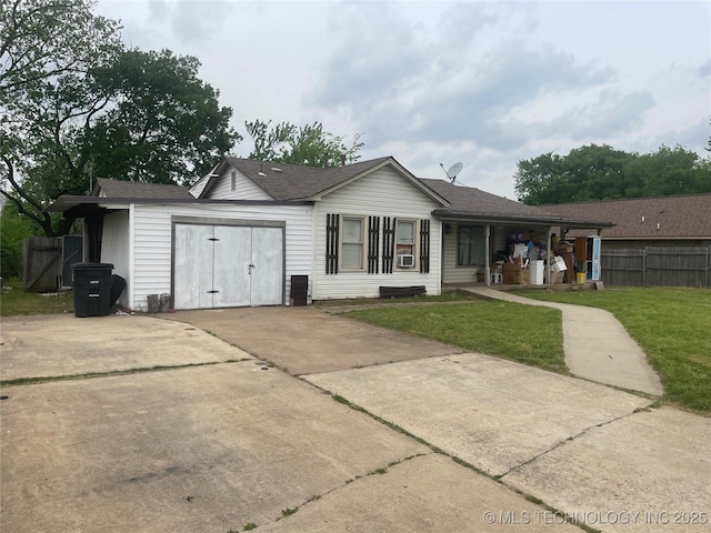 back of property with fence, a lawn, driveway, and roof with shingles