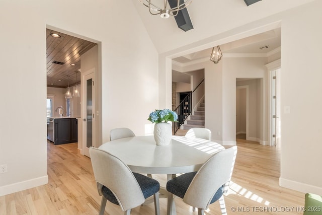 dining room with stairway, baseboards, and a notable chandelier