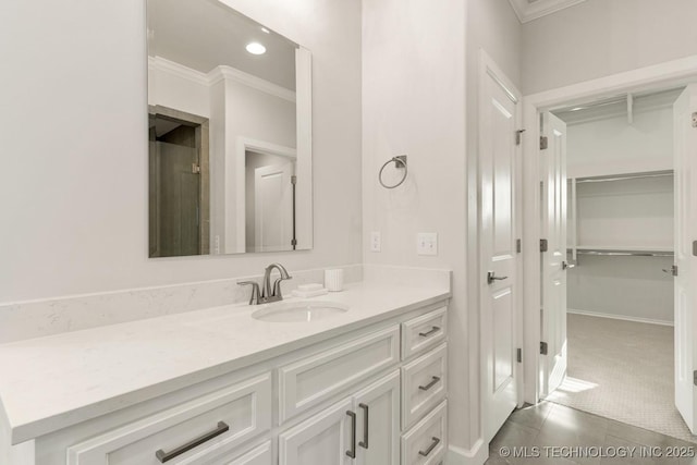 bathroom featuring recessed lighting, tile patterned flooring, vanity, ornamental molding, and a closet