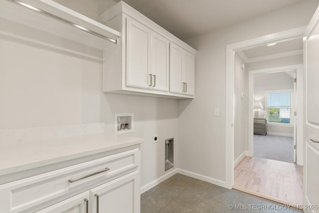 laundry area featuring electric dryer hookup, baseboards, washer hookup, and cabinet space