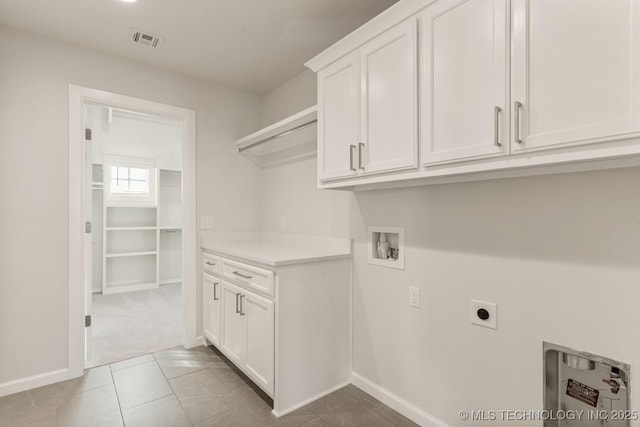 laundry area with visible vents, hookup for a washing machine, baseboards, electric dryer hookup, and cabinet space