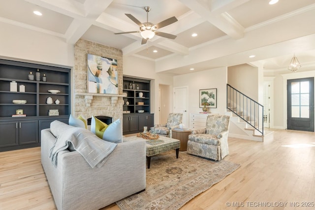 living area featuring recessed lighting, coffered ceiling, and stairway