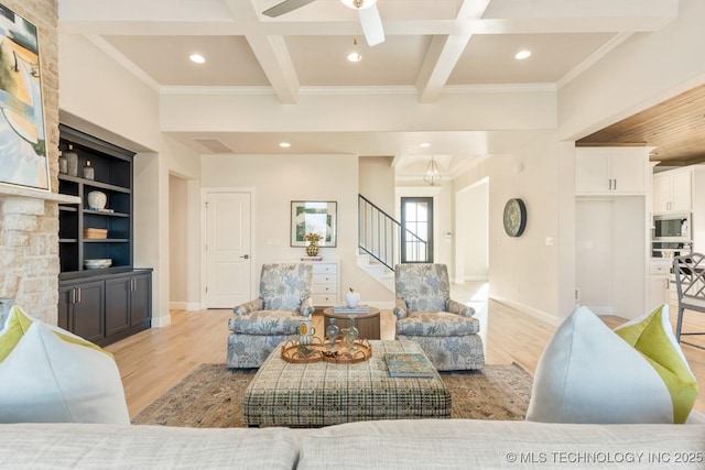 living room featuring light wood-style flooring, crown molding, stairway, and coffered ceiling