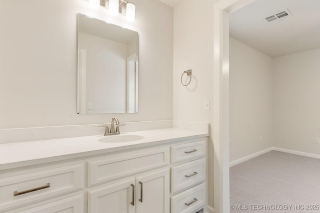 bathroom with baseboards, visible vents, and vanity