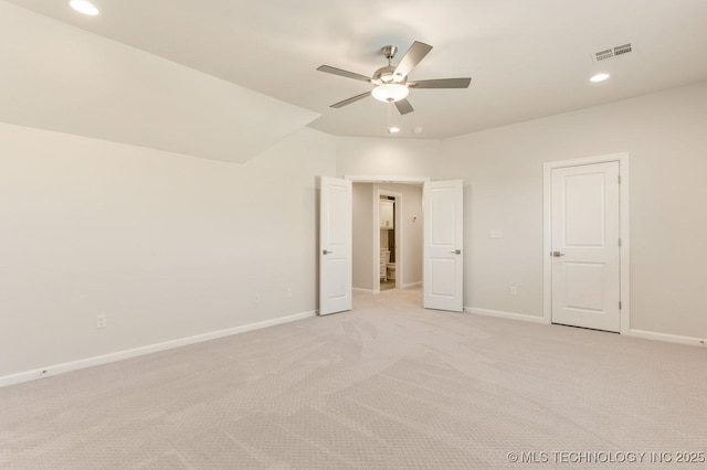 unfurnished bedroom featuring light carpet, baseboards, and recessed lighting