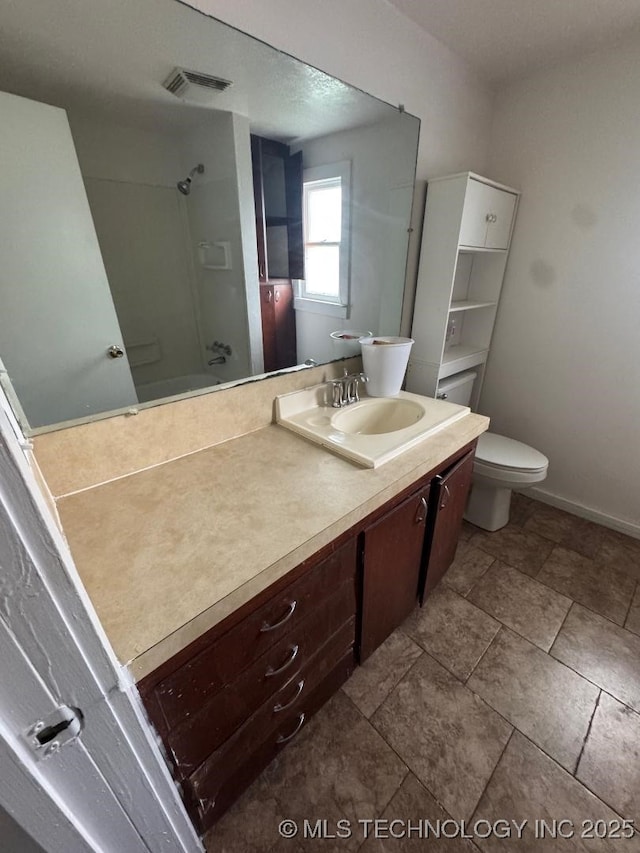 bathroom with vanity, walk in shower, baseboards, toilet, and visible vents