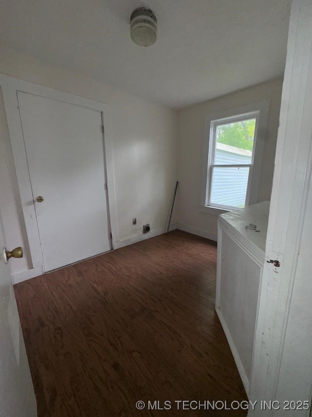 interior space featuring baseboards and wood finished floors