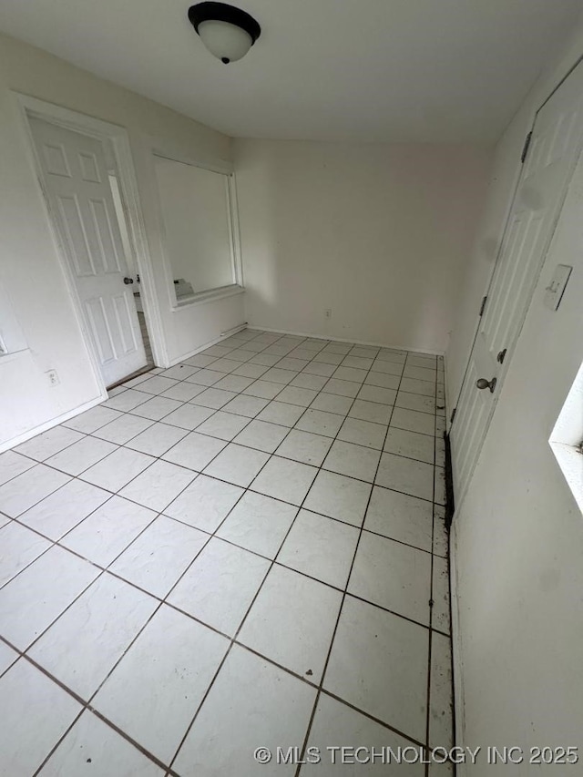 spare room featuring light tile patterned floors