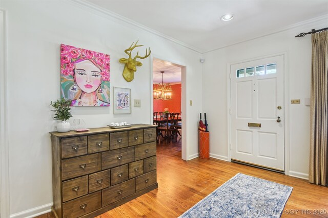 2412 E 23rd St, Tulsa, OK 74114 - entrance foyer with light wood-type flooring, baseboards, a chandelier, and ornamental molding