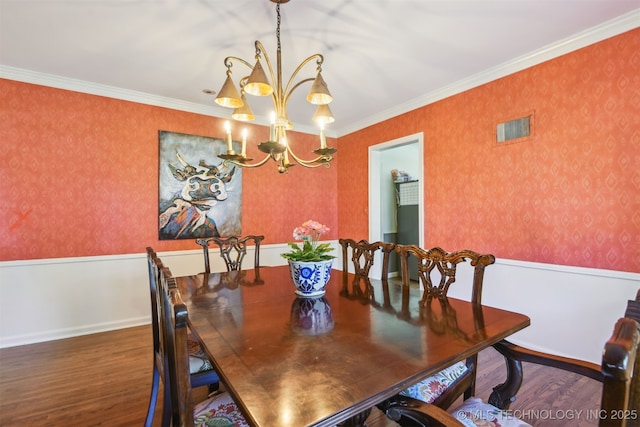 2412 E 23rd St, Tulsa, OK 74114 - dining space with a notable chandelier, wood finished floors, wallpapered walls, ornamental molding, and visible vents
