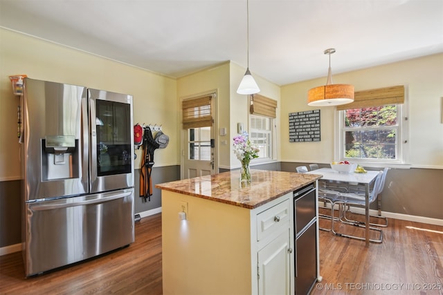 2412 E 23rd St, Tulsa, OK 74114 - kitchen with light stone countertops, a kitchen island, dark wood-style floors, and stainless steel fridge with ice dispenser
