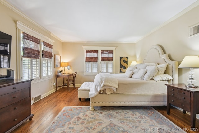2412 E 23rd St, Tulsa, OK 74114 - bedroom with ornamental molding, wood finished floors, and multiple windows