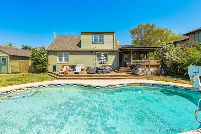 2412 E 23rd St, Tulsa, OK 74114 - back of house with an outdoor living space, an outdoor pool, a deck, fence, and a yard