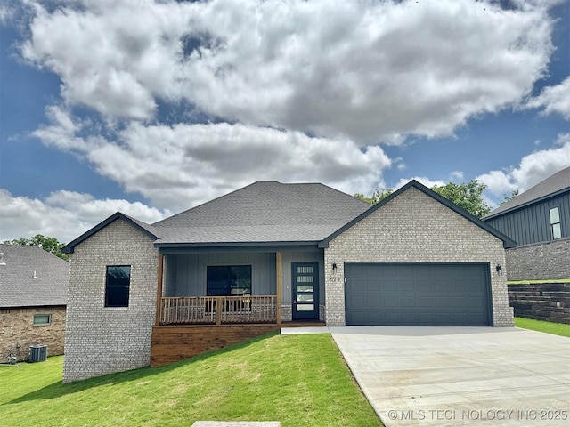 574 Woodlands Dr, Tahlequah, OK 74464 - view of front of home with a garage, brick siding, driveway, cooling unit, and a front yard