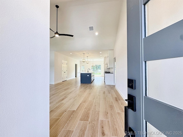 574 Woodlands Dr, Tahlequah, OK 74464 - corridor with light wood-style floors, a sink, recessed lighting, and baseboards