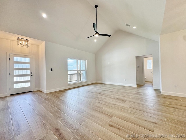 574 Woodlands Dr, Tahlequah, OK 74464 - unfurnished living room featuring a ceiling fan, light wood-style flooring, a chandelier, high vaulted ceiling, and baseboards