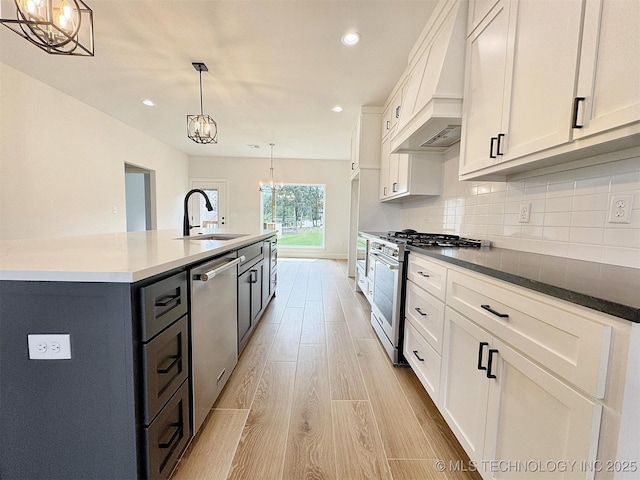 574 Woodlands Dr, Tahlequah, OK 74464 - kitchen with stainless steel appliances, a sink, premium range hood, a chandelier, and white cabinets