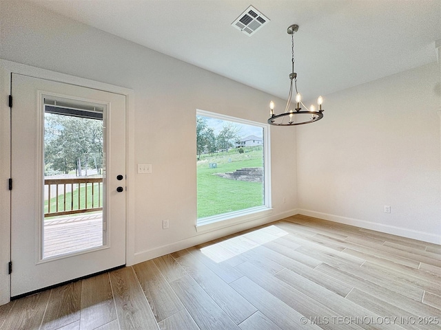 574 Woodlands Dr, Tahlequah, OK 74464 - unfurnished dining area featuring a chandelier, plenty of natural light, light wood-type flooring, and baseboards