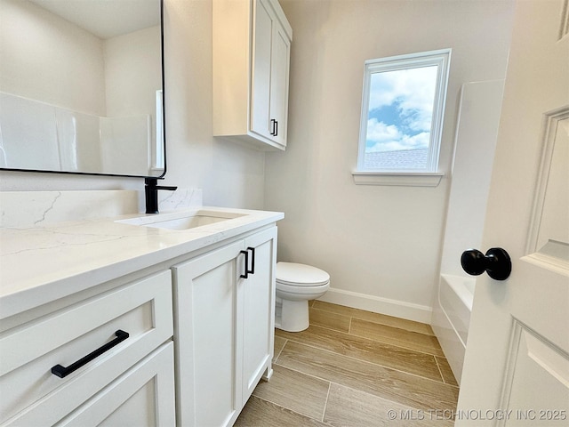 574 Woodlands Dr, Tahlequah, OK 74464 - bathroom featuring vanity, toilet, baseboards, shower / bathtub combination, and wood finished floors
