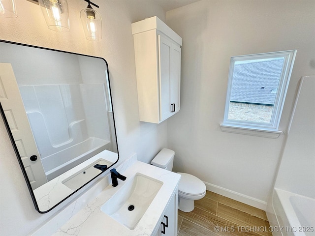 574 Woodlands Dr, Tahlequah, OK 74464 - bathroom featuring vanity, toilet, baseboards, and wood finished floors