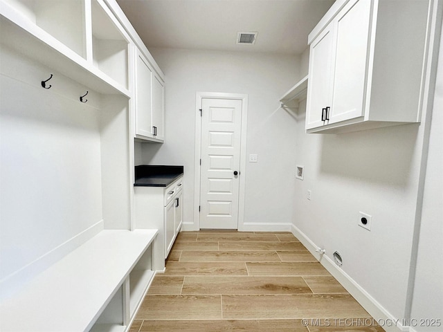 574 Woodlands Dr, Tahlequah, OK 74464 - laundry area featuring electric dryer hookup, hookup for a washing machine, cabinet space, gas dryer hookup, and light wood-style flooring