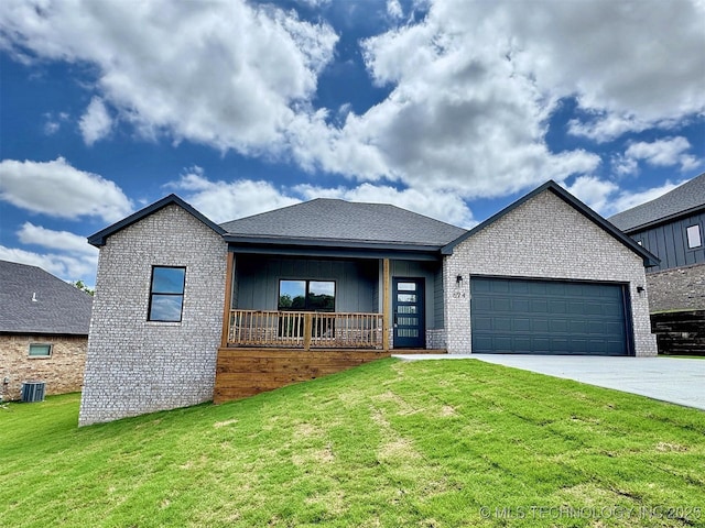 574 Woodlands Dr, Tahlequah, OK 74464 - view of front of home with concrete driveway, an attached garage, a front yard, and brick siding