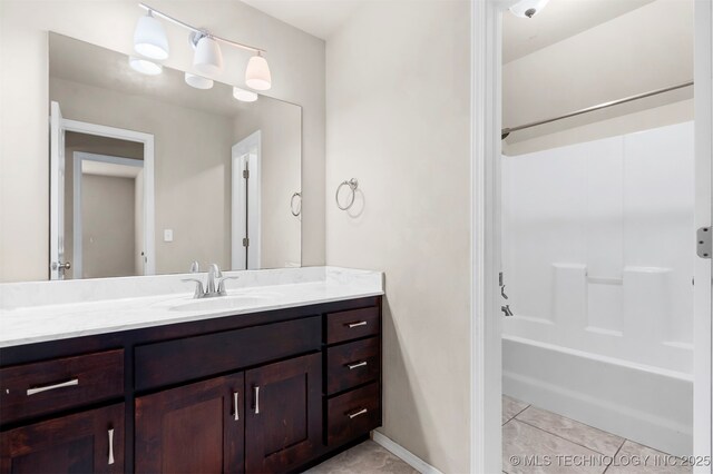 7056 E 124th St S, Bixby, OK 74008 - full bath featuring vanity, shower / washtub combination, tile patterned flooring, and baseboards