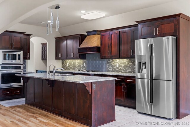 7056 E 124th St S, Bixby, OK 74008 - kitchen with stainless steel appliances, custom exhaust hood, a sink, and tasteful backsplash