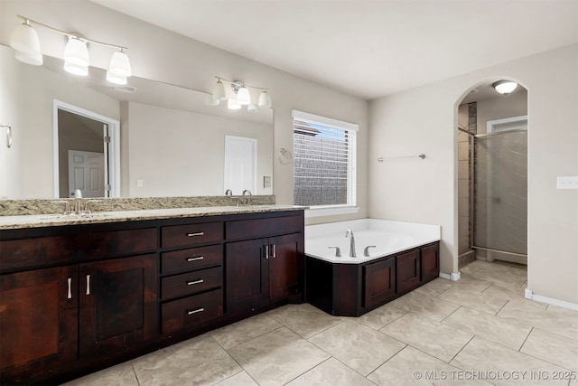 7056 E 124th St S, Bixby, OK 74008 - bathroom with double vanity, a stall shower, a garden tub, baseboards, and tile patterned flooring