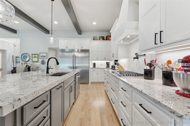 19340 E Canyon Ridge Rd, Owasso, OK 74055 - kitchen featuring white cabinets, beam ceiling, a sink, tasteful backsplash, and premium range hood