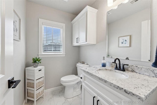 19340 E Canyon Ridge Rd, Owasso, OK 74055 - bathroom featuring toilet, vanity, marble finish floor, baseboards, and visible vents
