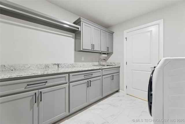 19340 E Canyon Ridge Rd, Owasso, OK 74055 - clothes washing area featuring cabinet space, washer / clothes dryer, marble finish floor, and a sink