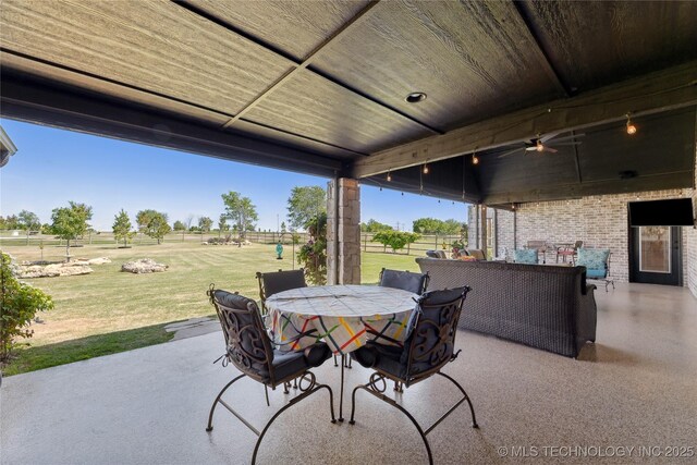 19340 E Canyon Ridge Rd, Owasso, OK 74055 - view of patio / terrace featuring outdoor dining area, fence, a rural view, and ceiling fan