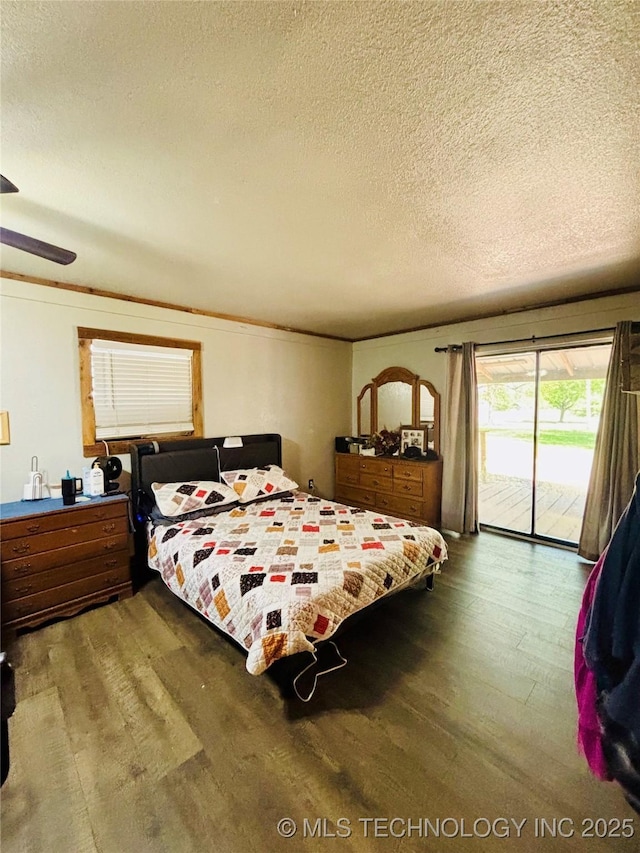 bedroom featuring a textured ceiling, wood finished floors, and access to exterior