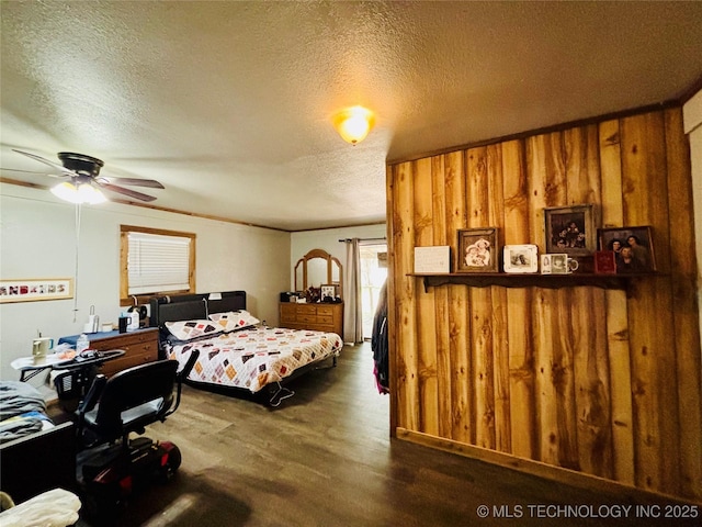 bedroom with a textured ceiling and dark wood-style floors