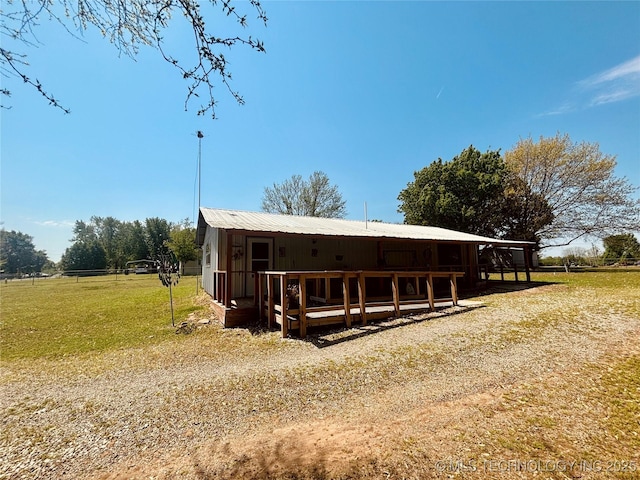 view of front of property with a front yard and metal roof