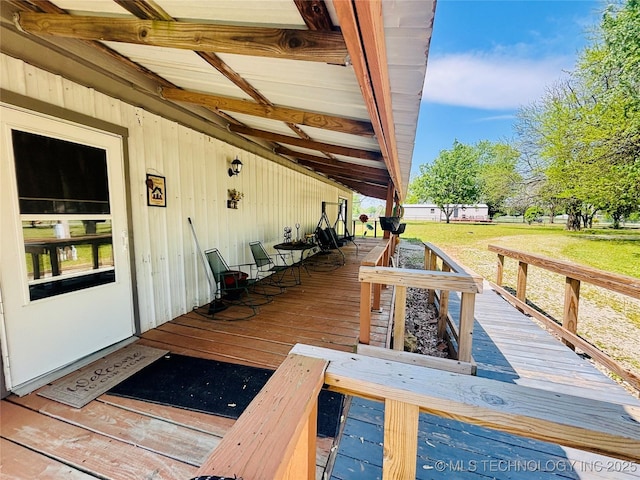 wooden deck with a lawn