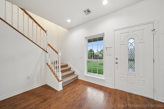 entryway with recessed lighting, baseboards, wood finished floors, visible vents, and stairway