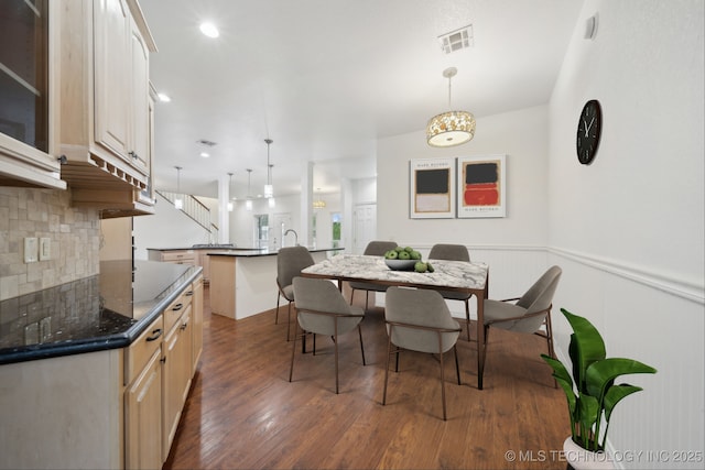 15015 E 74th Pl, Owasso, OK 74055 - dining area featuring wood finished floors and wainscoting