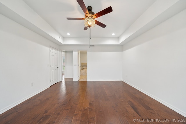 15015 E 74th Pl, Owasso, OK 74055 - spare room with a ceiling fan, a tray ceiling, baseboards, dark wood-style floors, and recessed lighting