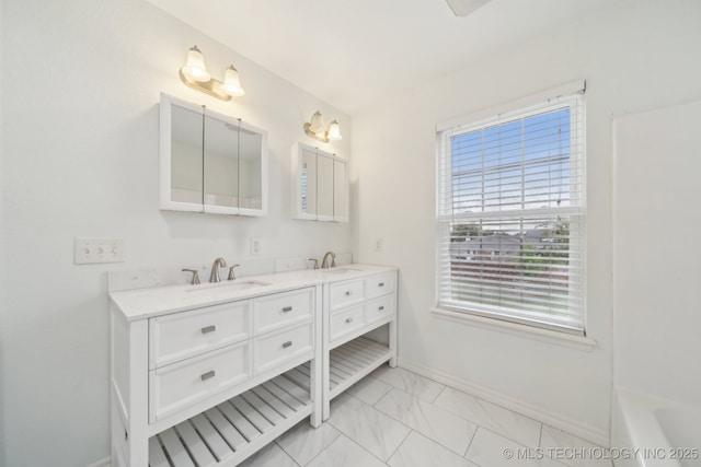 15015 E 74th Pl, Owasso, OK 74055 - full bath with baseboards, double vanity, marble finish flooring, and a tub to relax in