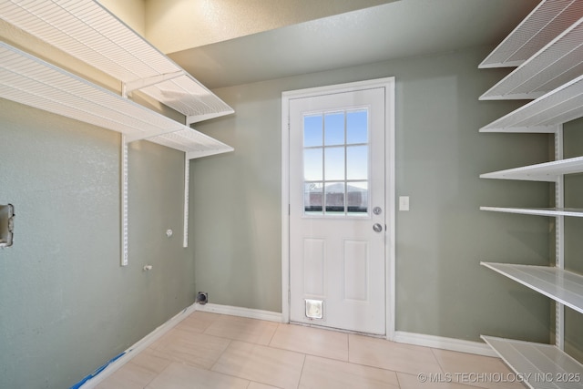 15015 E 74th Pl, Owasso, OK 74055 - laundry room with tile patterned floors, baseboards, and washer hookup