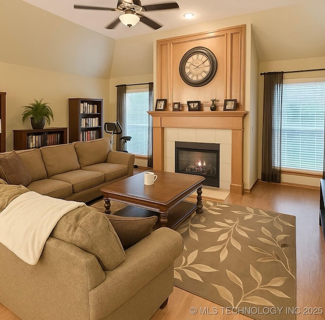 3701 Bridgeport Rd, Norman, OK 73072 - living area featuring a ceiling fan, light wood-type flooring, plenty of natural light, a fireplace, and vaulted ceiling