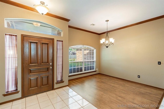 3701 Bridgeport Rd, Norman, OK 73072 - entryway featuring a chandelier, ornamental molding, and light tile patterned floors