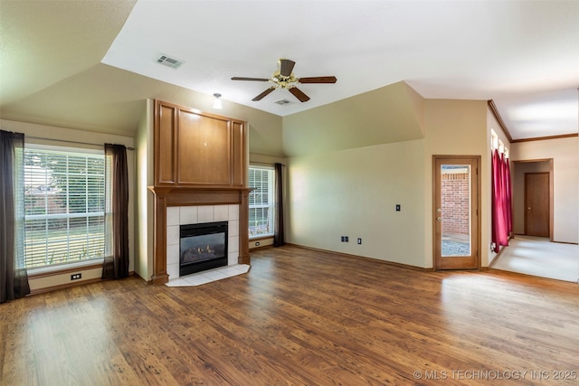 3701 Bridgeport Rd, Norman, OK 73072 - unfurnished living room with a ceiling fan, wood finished floors, a tile fireplace, and lofted ceiling