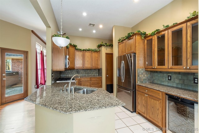 3701 Bridgeport Rd, Norman, OK 73072 - kitchen with appliances with stainless steel finishes, beverage cooler, brown cabinets, light stone counters, and tasteful backsplash