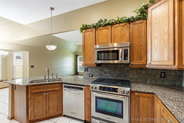 3701 Bridgeport Rd, Norman, OK 73072 - kitchen featuring stainless steel appliances, a peninsula, backsplash, light tile patterned floors, and vaulted ceiling